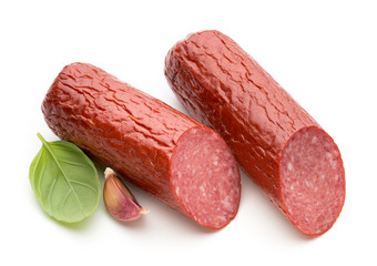 Salami smoked sausage, basil leaves on white background cutout.