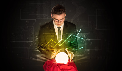 Young businessman making predictions of the future of the stock market with a magic ball
