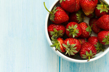 Strawberry . fresh berries of strawberry on a blue wood background / Top view.