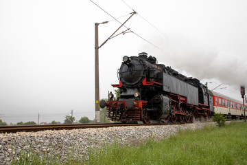 Fototapeta na wymiar Retro vintage steam locomotive on rail tracks