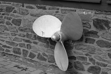 Ship propeller on a brick wall - Isolated helix (Germany, Europe)