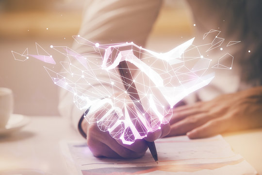 Abstract polygonal handshake on people hands writing background. Teamwork concept. Double exposure.