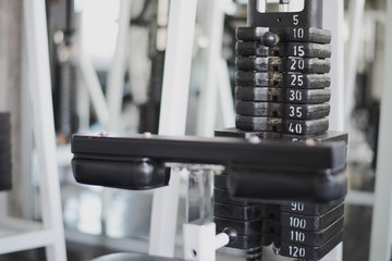 Gym weight equipment machine. Weight on lifting machine. Weight plate for training in fitness room