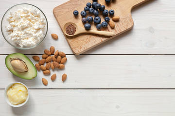 Keto food: eggs, avocado, butter, nuts, cream, berries. Healthy fats.