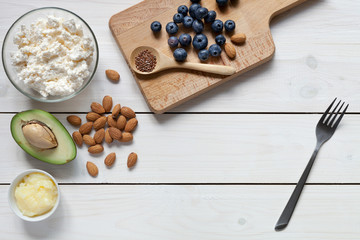 Keto food: eggs, avocado, butter, nuts, cream, berries. Healthy fats.
