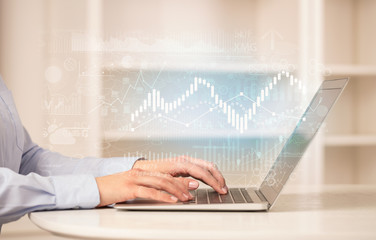 Business woman in homey environment using laptop with global financial report concept
