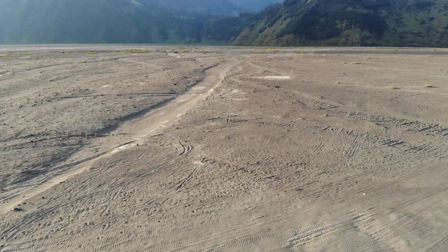 aerial video of motorbikes driving in sand environment