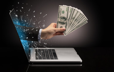 Hand with money coming out of a laptop with sparkling effects

