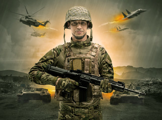 Armed soldier with sniper in the middle of a war

