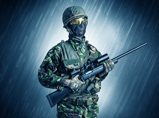 Armed soldier standing in rainy weather
