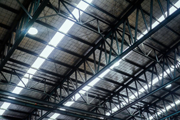 Roof steel beam structure in Industrial factory, Background of factory ceiling with one light blub, Abstract background