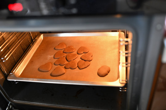 Heart shaped chocolate chip cookies in the oven. cookies from oven - Powered by Adobe