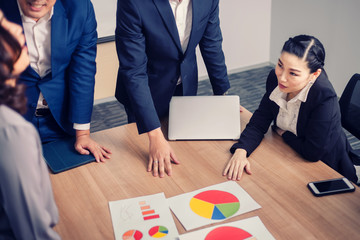 Teamwork with business people analysis cost graph in meeting room