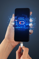 Elegant hand charging smartphone with global report concept
