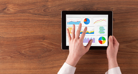 Hand making diagrams and charts on tablet