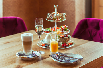 Breakfast. Croissants, coffee and champagne. Beautifully served breakfast of cheese, eggs, ham, fruit and vegetable salad