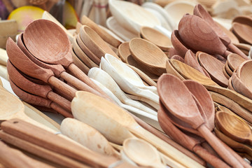 Wooden spoons made from different types of wood on the market counter