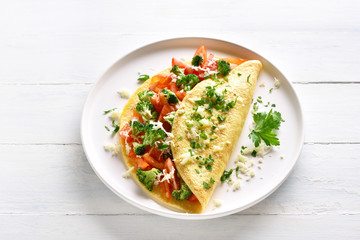 Omelette with tomatoes, red bell pepper and broccoli