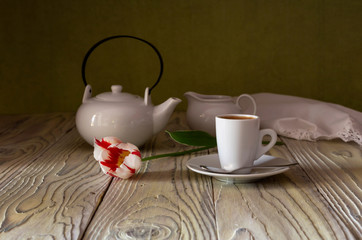 Cup with coffee and tulip