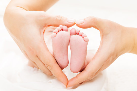 Newborn Baby Feet In Mother Hands Heart, Mom And New Born Kid Foot, Love And Health Care