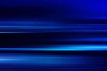 digitally generated image of blue light and stripes moving fast over black background