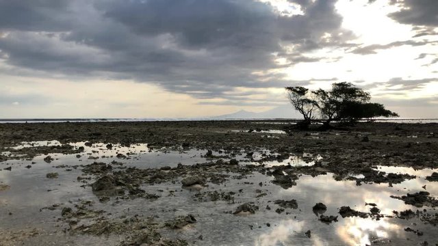 Great low tide on a coral reef in Bali, Indonesia at sunset