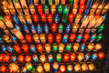 Many colorful candles in the Benedictine abbey Santa Maria de Montserrat 