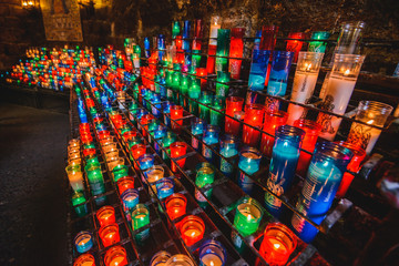Fototapeta premium Many colorful candles in the Benedictine abbey Santa Maria de Montserrat 