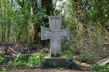 Cross pattee in a forest near Paris in France, Europe