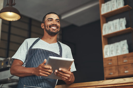 Portrait Of A Young Business Owner In His Cafe