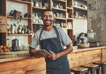 Portrait of a smiling young african cafe owner