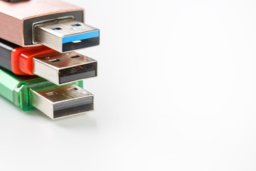 Detailed view of a black USB flash drive with a silver-blue connector. Photo on a white background