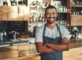 Friendly confident male owner at his cafe