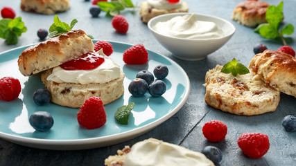 Classic English scones with clotted cream, strawberries jam and other fruit