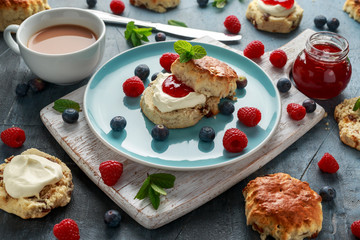 Classic scones with clotted cream, strawberries jam, english Tea and other fruit