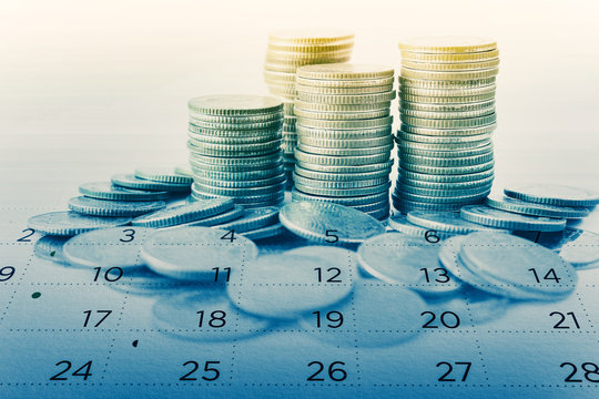 double exposure of rows of coins and calendar for business and finance background