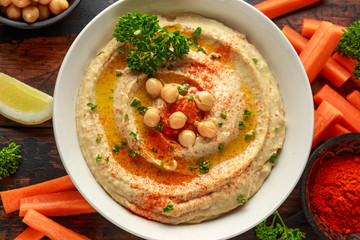 Hummus with olive oil, paprika, lemon and carrot.