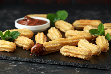 Churros with chocolate dipping sauce. sugar and cinnamon.