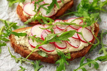 Hummus sourdough toast with reddish and wild rocket. Healthy vegan food