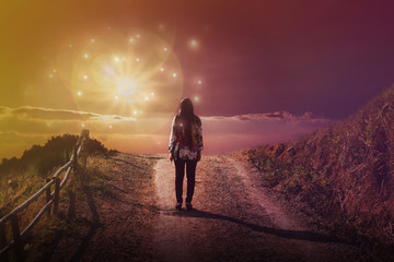 Women rare view standing in front of God sun light flare with dreamy fantasy sky and cloud, women...