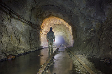 Underground mineshaft gold iron ore tunnel with miner