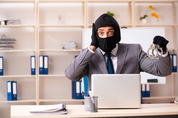 Male gangster stealing information from the office 