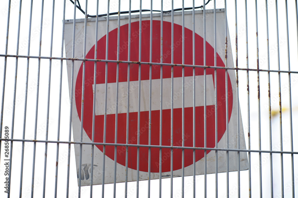 Wall mural Red and White British No Entry Road Sign with Steel Fence, Red Stop Road Sign, Traffic Sign Prohibiting, Fence Grilles Rust Texture Background, Warning Sign at Fence Wall, Prohibition Sign