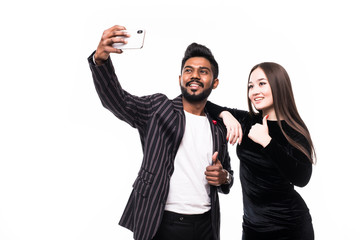 Young Asian Couple taking selfie on the phone isolated on white background