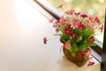 Flowers bag on table with window background