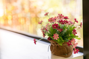 Flowers bag on table with window background