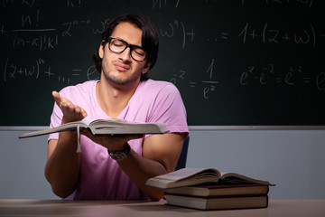Young male student sitting in classroom