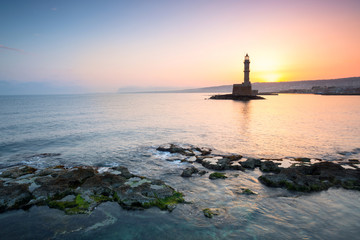 Fototapeta premium Lighthouse in the port of Chania at sunrise on Crete, Greece