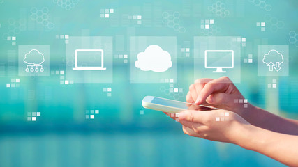 Cloud computing with person holding a white smartphone