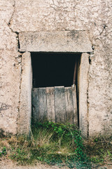 Wooden old door on a stone wall